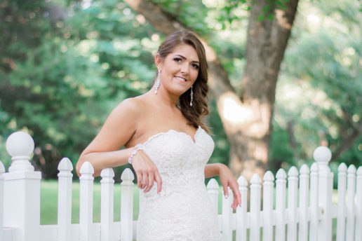 Bride posing near fence