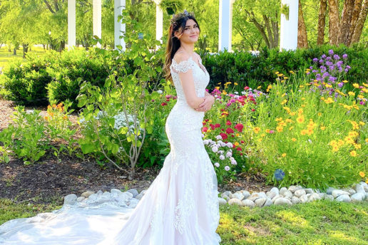 Bride posing with flowers